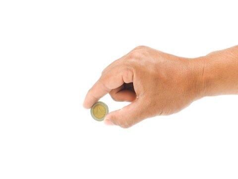A man's hand holds a coin in his hand and is about to put the coin into something. Isolated on white background. business idea.