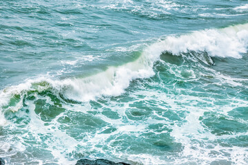 Fototapeta premium Wave splashing close-up. Crystal clear sea water, in the ocean in San Francisco Bay, blue water, pastel colors.