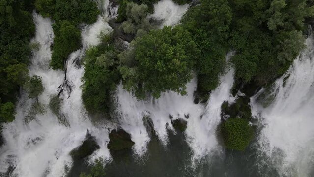 Aerial view of Kravica Waterfalls (Vodopad Kravica), Bosnia and Herzegovina, waterfall flowing through trees