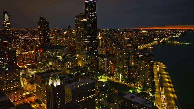 Illuminated city night cityscape Aerial shot in a city Crowded streets and heavy traffic 4K Drone Footage

