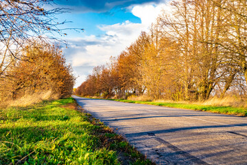 Beautiful empty asphalt road in countryside on colored background