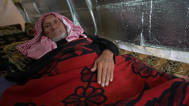 A crippled elderly man lives in a dilapidated tent. Displaced people in northwestern Syria suffer from difficult humanitarian conditions in the winter