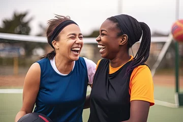 Deurstickers sports friends netball players court happy laughing bond while training outdoors funny women sport team members bonding humor joke silly conversation match practice © sandra