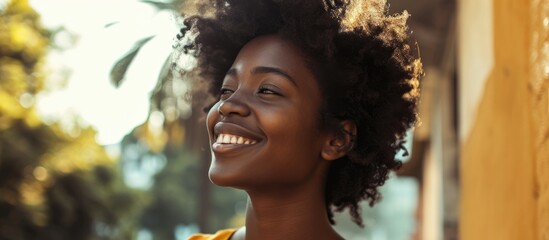 Confidently smiling African American woman in casual clothes, looking to the side in a relaxed profile pose.