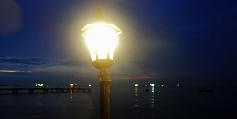 Light from lamp beside sea at night, Lighting design