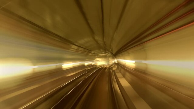 Time lapse of motion blurred tube lines in tunnel of automatic train	 High-speed dash through city's underground veins, world transforms into blur of gold and shadow, Hyperlapse