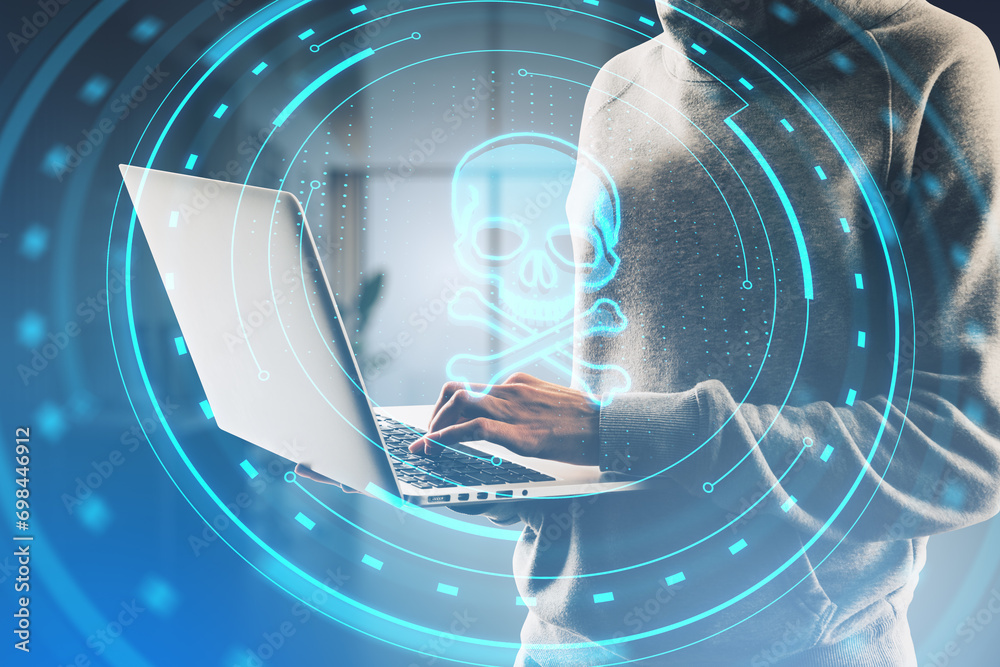 Aufkleber Close up of hacker hands using laptop with abstract round skull interface on blurry office background. Hacking and threat concept. Double exposure.