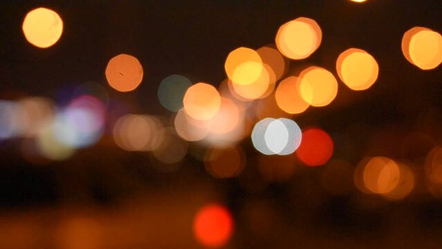 Beautiful bokeh on night background with blurry lights. Night lights in city, haze, depth of field, round bokeh, circle bokeh