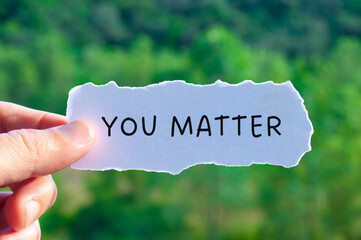 You matter text on torn white paper with nature background. Motivational and Inspirational concept
