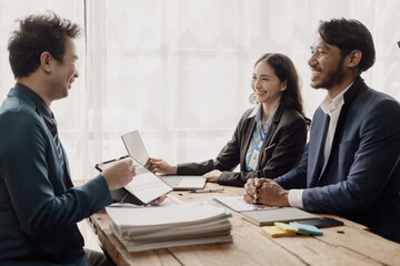 Smart businessman and businesswoman discuss in group meeting at table, strategic planning, business collaboration and brainstorming, problem solving with colleagues in office.