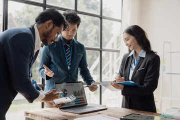 Smart businessman and businesswoman discuss in group meeting at table, strategic planning, business collaboration and brainstorming, problem solving with colleagues in office.