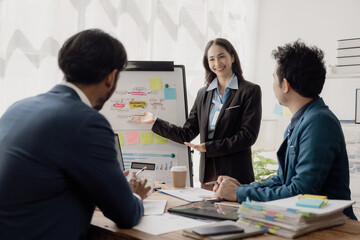 Smart businessman and businesswoman discuss in group meeting at table, strategic planning, business collaboration and brainstorming, problem solving with colleagues in office.