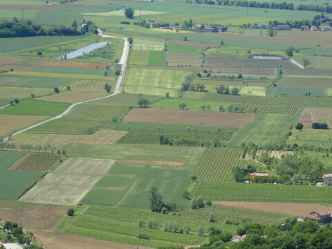 Fototapeta panorama seen from above of the plain with the cultivated fields divided into geometric shapes in spring