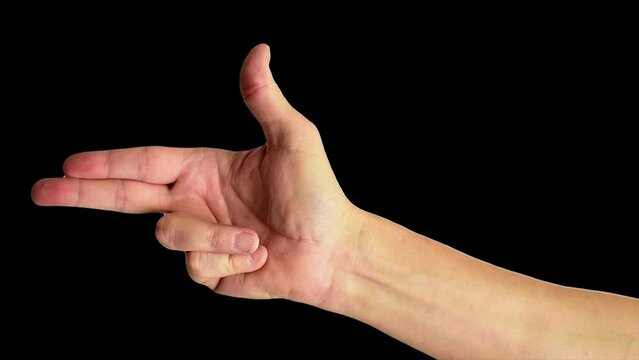 Close up shot of a male hand making the classic fingers gun sign, against a plain black background