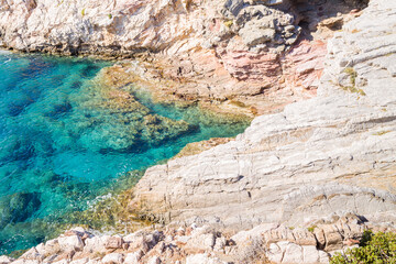 The rocky coast and its arid cliffs , in Europe, Greece, Crete, Agios Pavlos, By the Mediterranean Sea, in summer, on a sunny day.