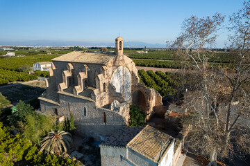 High angle view of the old Hermitage of Santa Barbara church among orange trees in Burriana, Spain