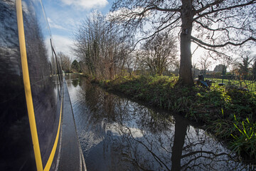 Narrowboat on a British canal in rural setting