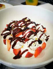 Delicious vanilia ice cream with fruits in a plate