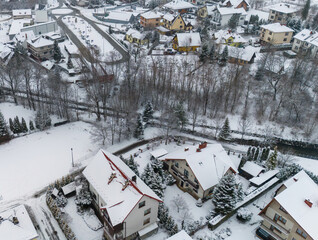 Drone shot of a small town named Limanowa in mountains in Poland covered with fog and snow
