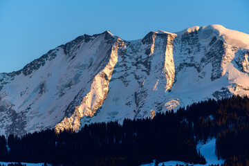 The cliffs of Domes de Miage lit by the Sun in Europe, France, Rhone Alpes, Savoie, Alps, in winter on a sunny day.