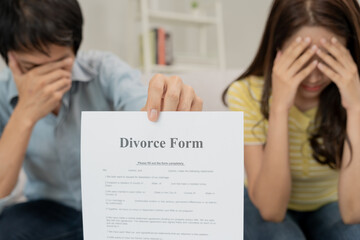 Divorce. Woman remove married ring and sign Divorce form. Couples desperate and disappointed after...