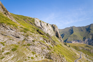 The Mountains around Gavarnie Gedre in the arid green countryside , Europe, France, Occitanie, Hautes-Pyrenees, in summer on a sunny day.