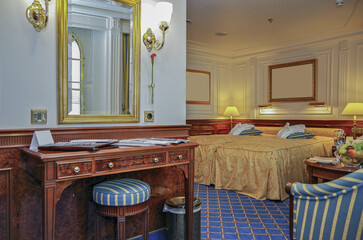 Bedroom living area of oceanview suite cabin stateroom in cozy opulent Art Nouveau interior design...