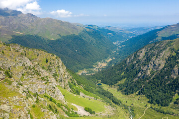 Fototapeta na wymiar The Valley of Espone in the middle of the mountains and its green countryside , in Europe, in France, Occitanie, in the Hautes-Pyrenees, in summer, on a sunny day.