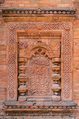 Obraz premium Detail vertical view of brick and terracotta decor on exterior wall of ancient medieval Khania Dighi mosque, Shahabazpur, Chapai Nawabganj, Bangladesh