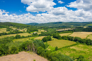 Fototapeta na wymiar The countryside with its forests and green fields in Europe, France, Burgundy, Nievre, towards Chateau Chinon, in summer, on a sunny day.