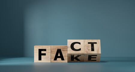 Flipping Wooden cube block for change fake to fact , news and social media concept. - obrazy, fototapety, plakaty