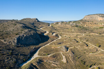 Peaks of a rocky mountain in the arid countryside , Europe, Greece, Peloponnese, Argolis, Nafplion, Myrto seashore, in summer on a sunny day.