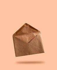 Envelope made of kraft paper on beige background. Design template.