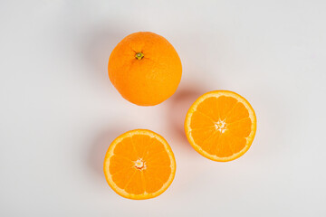 Orange slice isolate. Orange fruit half and slice set on white background.