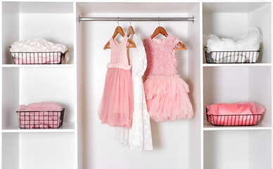 White dressing room with lush carnival dresses. Storage organization concept.