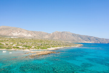 The rocky coast and its arid mountains , in Europe, Greece, Crete, Elafonisi, By the Mediterranean Sea, in summer, on a sunny day.