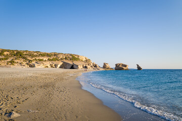 Fototapeta na wymiar The rocks by Triopetra Beach , in Europe, Greece, Crete, towards Rethymno, By the Mediterranean Sea, in summer, on a sunny day.
