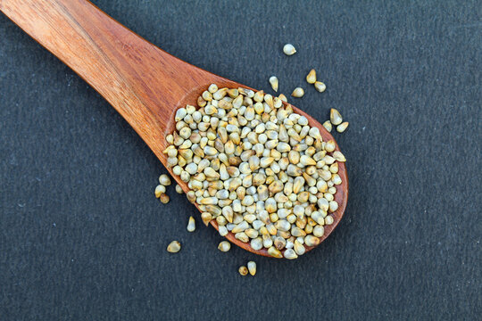 Organic Pearl millet or bajra in a wooden spoon close-up view 