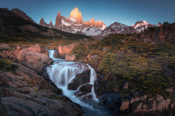 Beautiful Mt.fitzroy with giant waterfall as foreground  and sunrise in the morning (El chalten,...