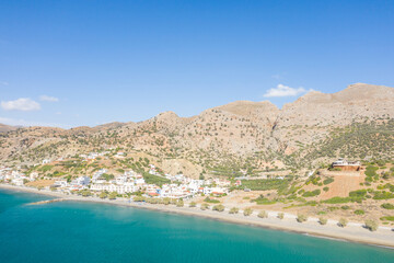 The city center at the foot of the arid mountains , in Europe, Greece, Crete, Tsoutsouros, By the Mediterranean Sea, in summer, on a sunny day.