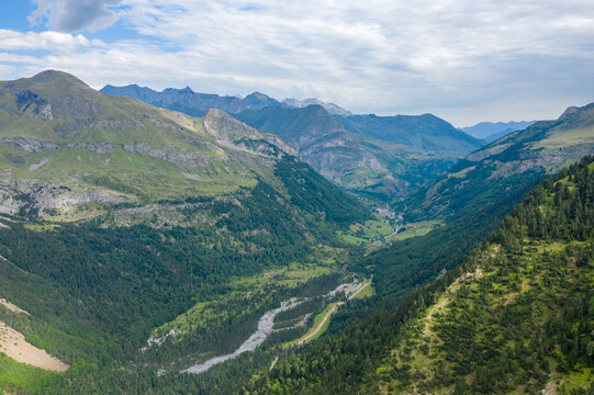 The Gavarnie Valley in the middle of the mountains and its green countryside , in Europe, in France, Occitanie, in the Hautes-Pyrenees, in summer, on a sunny day.