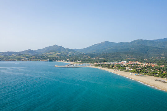 The white sand beach on the green coast in Europe, France, Occitanie, Pyrenees Orientales, Argeles, By the Mediterranean Sea, in summer, on a sunny day.