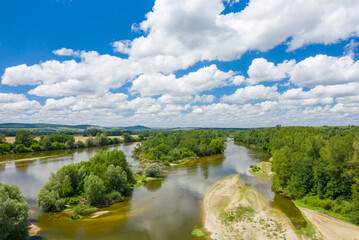 Fototapeta na wymiar Loire river in the middle of green countryside in Europe, France, Burgundy, Nievre, Pouilly sur Loire, towards Nevers, in summer, on a sunny day.