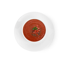 Delicious tomato cream soup with spices in bowl isolated on white, top view