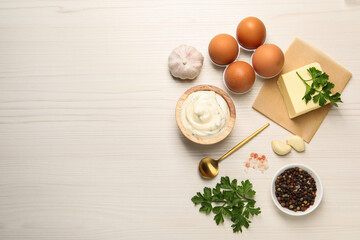 Tasty sauce with garlic and ingredients on white wooden table, flat lay. Space for text