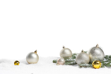 Beautiful Christmas balls, fir tree branch and sleigh bells on snow against white background