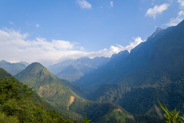 The Fan Si Pan massif and its green mountains, in Asia, in Vietnam, in Tonkin, towards Sapa, in summer, on a sunny day.
