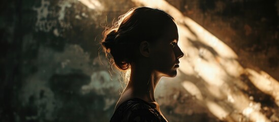 Shadowed female silhouette, backlit light.