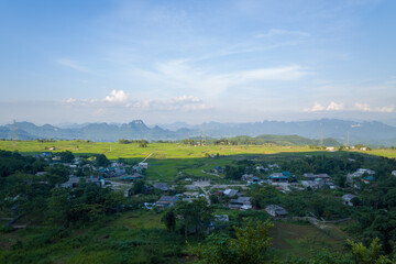A traditional village in the middle of countryside and mountains, in Asia, Vietnam, Tonkin, towards Hanoi, Mai Chau, in summer, on a sunny day.