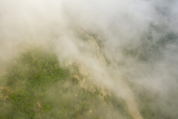 The green countryside under the clouds in Europe, France, in the Pyrenees, in summer, on a sunny day.